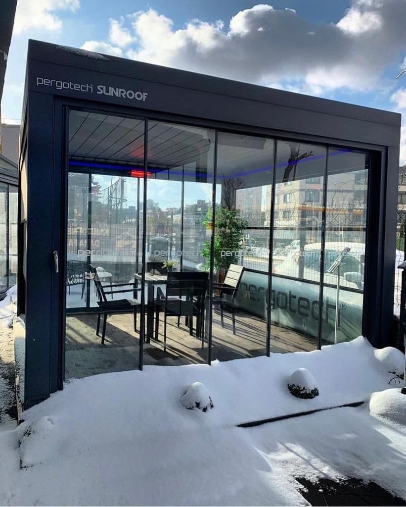 Bioclimatic pergola with glass walls in the snow