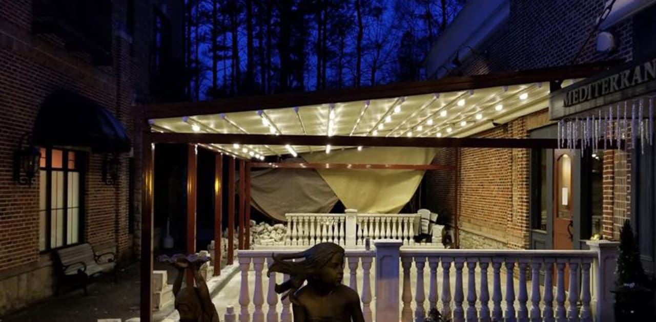 Efendi Mediterranean patio under a lit retractable roof