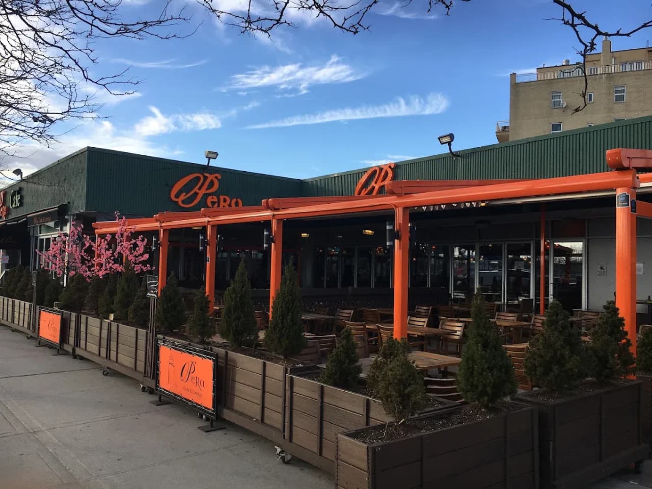 Opera Cafe & Lounge terrace under an orange-framed retractable roof