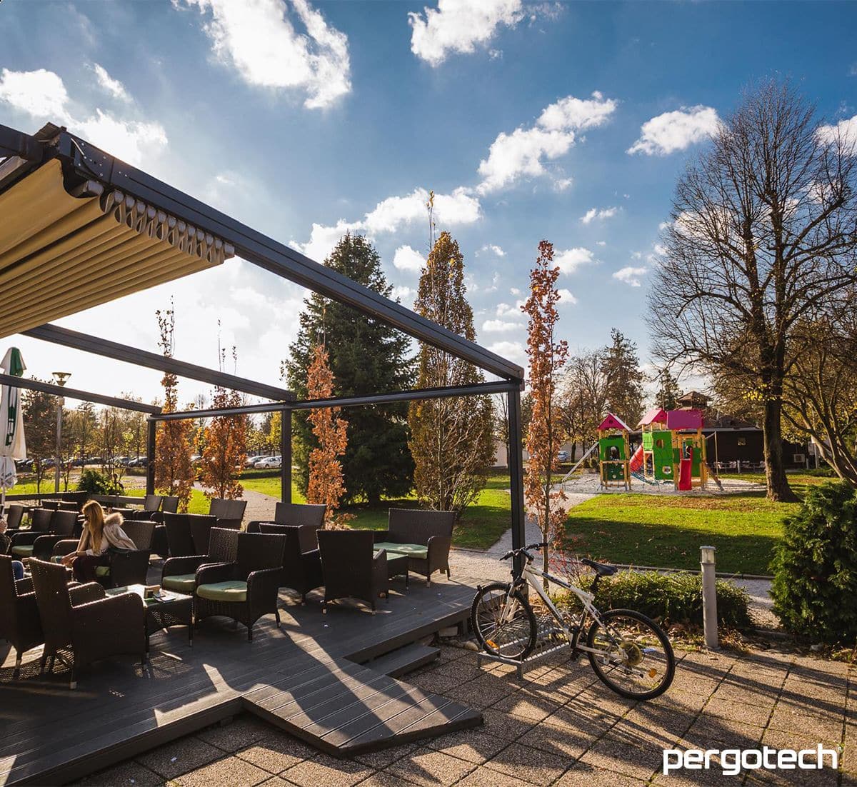 Retractable roof over a park café terrace in autumn